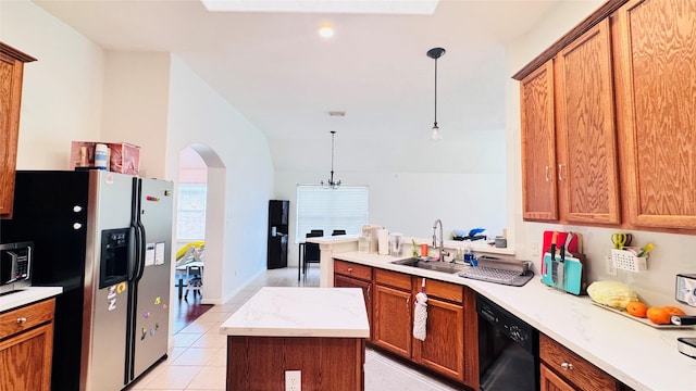 25023 Ivy Trace Ln, Katy, TX 77494 - kitchen featuring black appliances, arched walkways, a sink, pendant lighting, and light tile patterned flooring