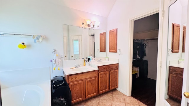25023 Ivy Trace Ln, Katy, TX 77494 - full bathroom with lofted ceiling, vanity, tile patterned floors, a spacious closet, and a tub