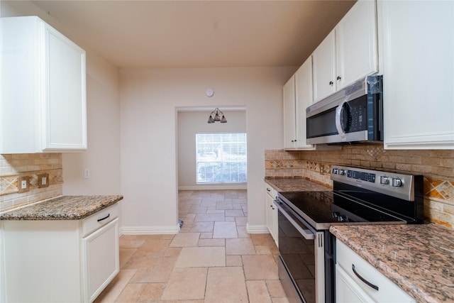 19422 Harvest Stream Way, Houston, TX 77084 - kitchen featuring appliances with stainless steel finishes, baseboards, light stone counters, stone tile floors, and white cabinetry