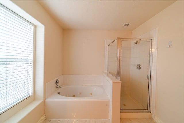 19422 Harvest Stream Way, Houston, TX 77084 - full bathroom featuring a stall shower, a jetted tub, tile patterned floors, and baseboards