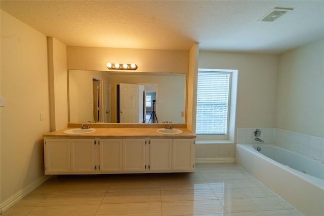 19422 Harvest Stream Way, Houston, TX 77084 - bathroom featuring double vanity, tile patterned floors, a bath, and baseboards
