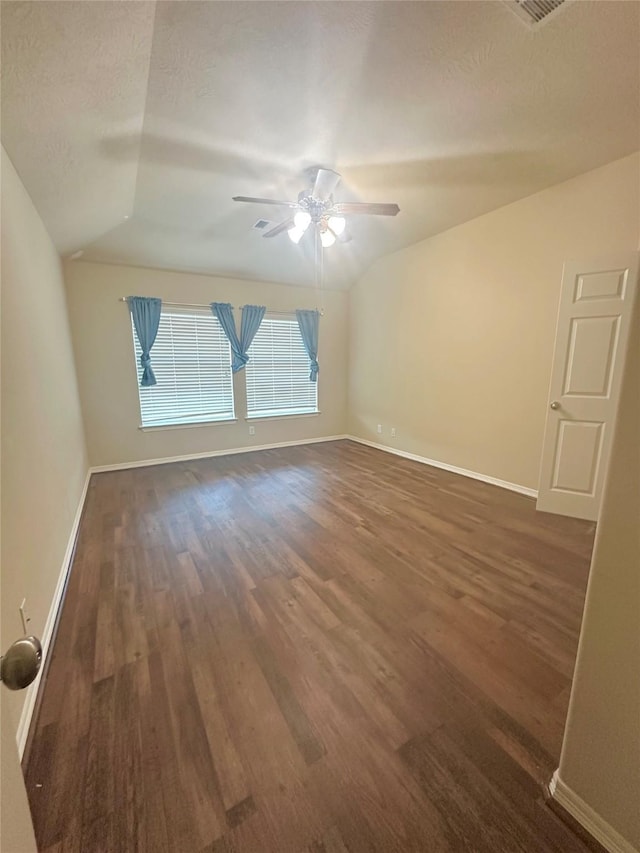 8239 Polaris Point Ln, Cypress, TX 77433 - empty room with vaulted ceiling, wood finished floors, a ceiling fan, baseboards, and a textured ceiling