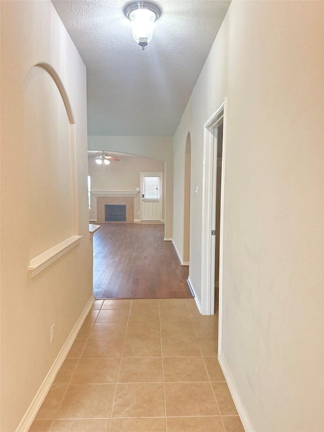 8239 Polaris Point Ln, Cypress, TX 77433 - corridor with light tile patterned flooring, baseboards, and a textured ceiling