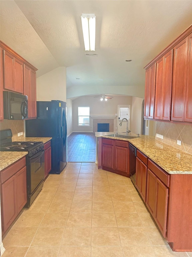 8239 Polaris Point Ln, Cypress, TX 77433 - kitchen with black appliances, a sink, a ceiling fan, light tile patterned floors, and backsplash
