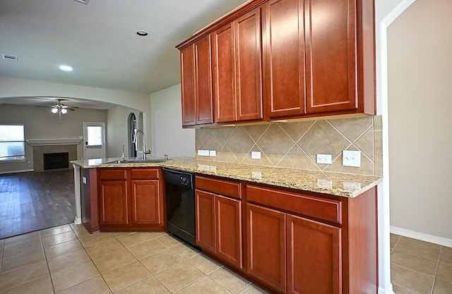 8239 Polaris Point Ln, Cypress, TX 77433 - kitchen with dishwasher, ceiling fan, a peninsula, tasteful backsplash, and a fireplace