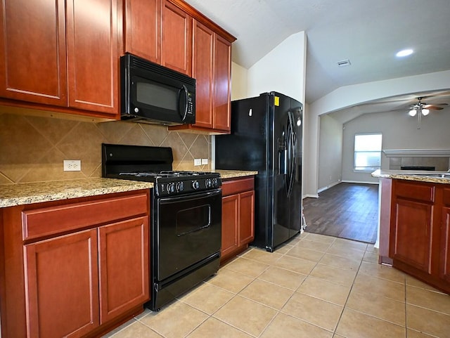 8239 Polaris Point Ln, Cypress, TX 77433 - kitchen featuring black appliances, lofted ceiling, ceiling fan, backsplash, and light stone counters