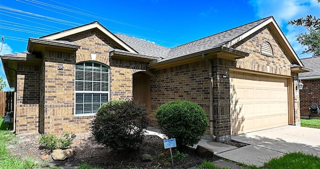 8239 Polaris Point Ln, Cypress, TX 77433 - view of side of property featuring brick siding, a garage, a shingled roof, and driveway