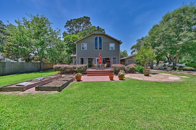 1026 Atchison St, Sealy, TX 77474 - back of house featuring a garden and a patio