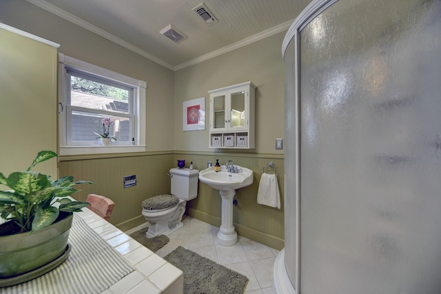 1026 Atchison St, Sealy, TX 77474 - bathroom with tile patterned floors, a shower stall, ornamental molding, and wainscoting