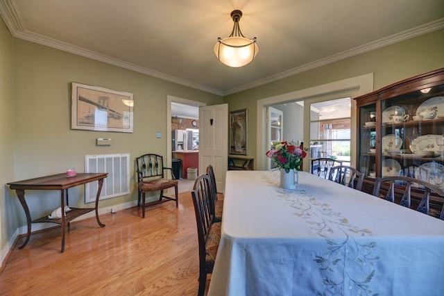 1026 Atchison St, Sealy, TX 77474 - dining room featuring light wood finished floors and ornamental molding