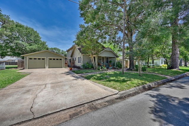 1026 Atchison St, Sealy, TX 77474 - view of front of home with a garage, an outbuilding, and covered porch