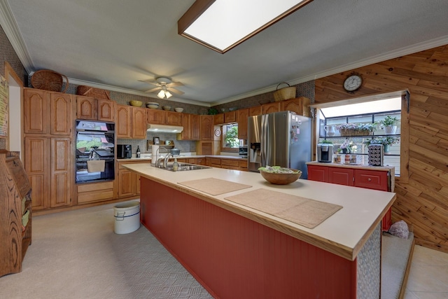 1026 Atchison St, Sealy, TX 77474 - kitchen featuring stainless steel fridge with ice dispenser, a large island with sink, light countertops, ceiling fan, and crown molding