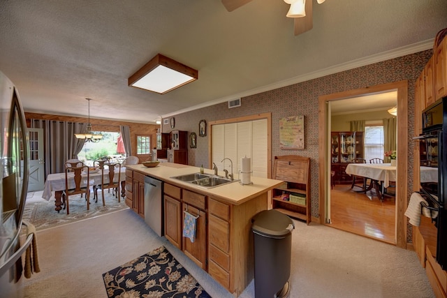 1026 Atchison St, Sealy, TX 77474 - kitchen with light colored carpet, ornamental molding, appliances with stainless steel finishes, a kitchen island with sink, and wallpapered walls
