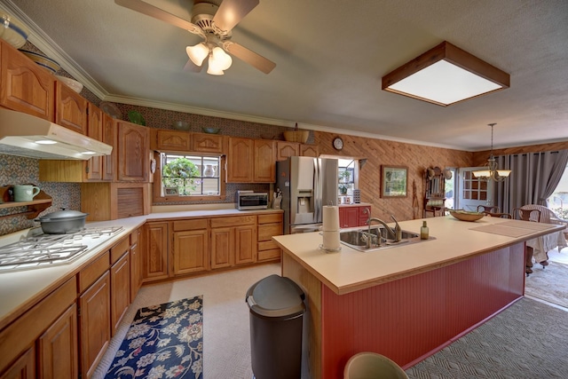 1026 Atchison St, Sealy, TX 77474 - kitchen with stainless steel fridge, under cabinet range hood, light carpet, a ceiling fan, and light countertops