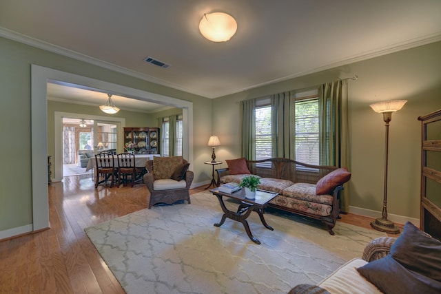 1026 Atchison St, Sealy, TX 77474 - living room with crown molding, plenty of natural light, and wood finished floors
