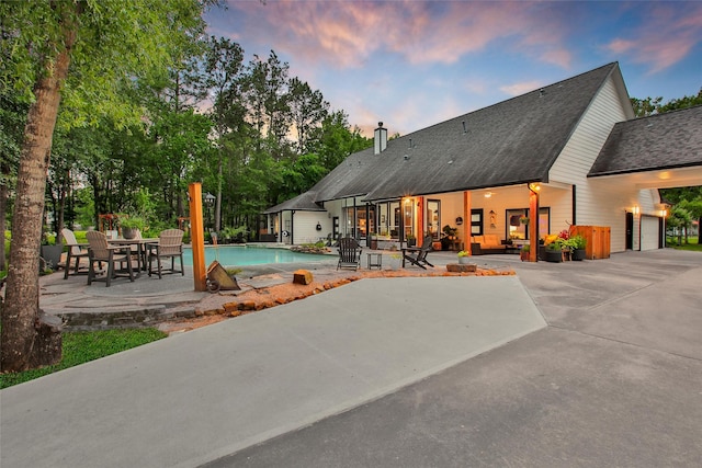11698 Creek View Ln, Conroe, TX 77385 - pool at dusk with a patio area and an outdoor pool