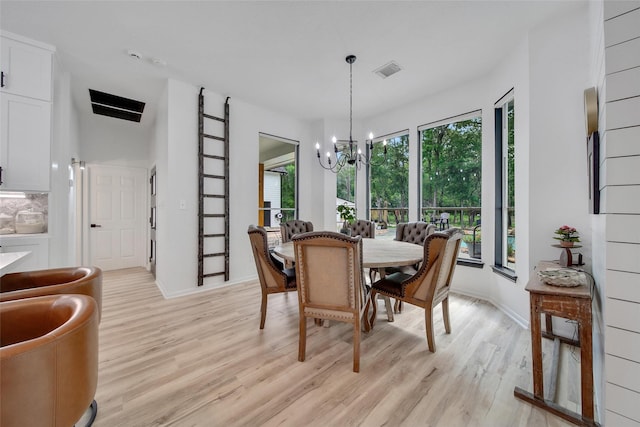 11698 Creek View Ln, Conroe, TX 77385 - dining area with light wood-style floors, a chandelier, and baseboards
