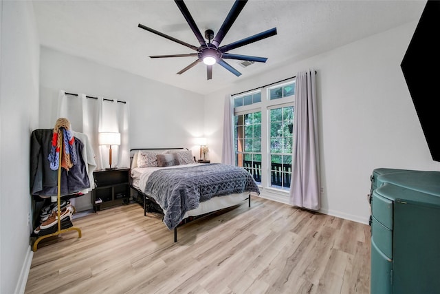 11698 Creek View Ln, Conroe, TX 77385 - bedroom featuring wood finished floors, baseboards, ceiling fan, and access to exterior