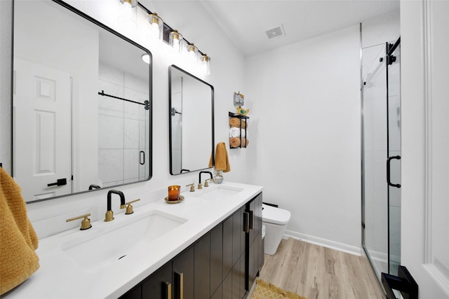 11698 Creek View Ln, Conroe, TX 77385 - full bath with wood finished floors, a shower stall, double vanity, toilet, and baseboards