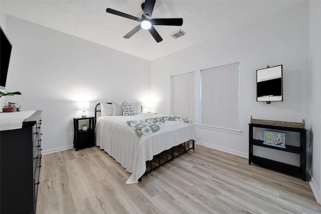 11698 Creek View Ln, Conroe, TX 77385 - bedroom with light wood finished floors, baseboards, and a ceiling fan