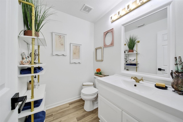 11698 Creek View Ln, Conroe, TX 77385 - bathroom featuring toilet, vanity, wood finished floors, and baseboards