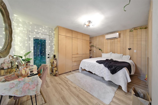 11698 Creek View Ln, Conroe, TX 77385 - bedroom with light wood-type flooring, a wall mounted AC, and wooden walls