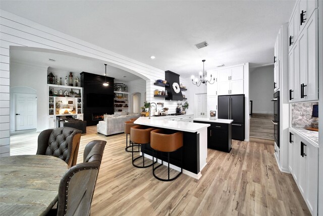 11698 Creek View Ln, Conroe, TX 77385 - kitchen featuring freestanding refrigerator, light countertops, a center island, and a chandelier