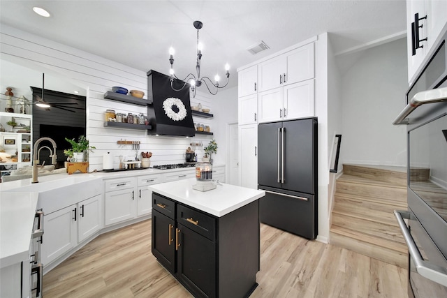 11698 Creek View Ln, Conroe, TX 77385 - kitchen with high end fridge, white cabinetry, extractor fan, light countertops, and open shelves