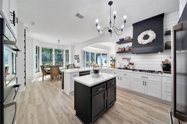 11698 Creek View Ln, Conroe, TX 77385 - kitchen featuring a chandelier, light countertops, white cabinetry, light wood-style flooring, and hanging light fixtures