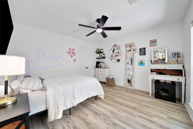 11698 Creek View Ln, Conroe, TX 77385 - bedroom featuring light wood-type flooring, a ceiling fan, and baseboards