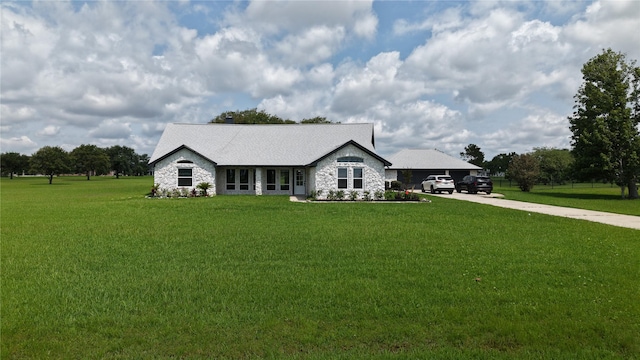 9035 N Point Dr, Beach City, TX 77523 - view of front facade with stone siding, a front lawn, and concrete driveway