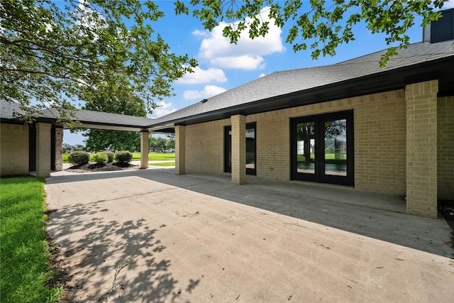 9035 N Point Dr, Beach City, TX 77523 - view of property exterior with brick siding and french doors