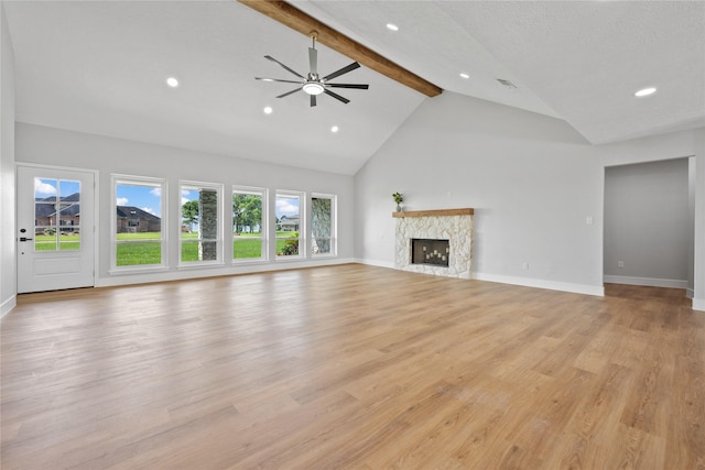 9035 N Point Dr, Beach City, TX 77523 - unfurnished living room with beam ceiling, a fireplace, light wood-style floors, baseboards, and high vaulted ceiling