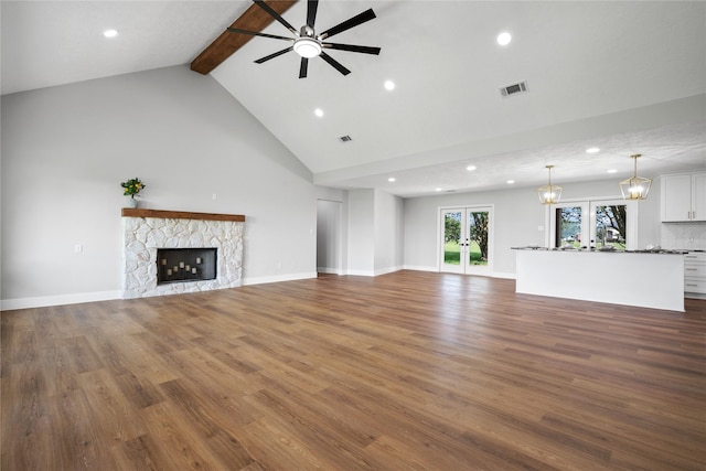 9035 N Point Dr, Beach City, TX 77523 - unfurnished living room featuring high vaulted ceiling, recessed lighting, beam ceiling, ceiling fan, and a stone fireplace