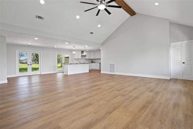 9035 N Point Dr, Beach City, TX 77523 - unfurnished living room featuring high vaulted ceiling, french doors, beamed ceiling, recessed lighting, and ceiling fan