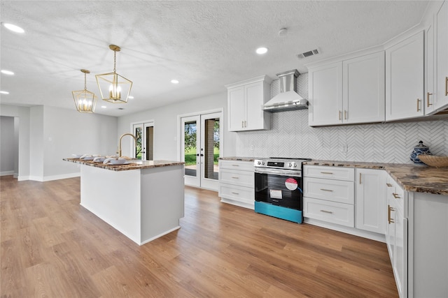 9035 N Point Dr, Beach City, TX 77523 - kitchen with wall chimney exhaust hood, electric stove, tasteful backsplash, recessed lighting, and light wood-type flooring