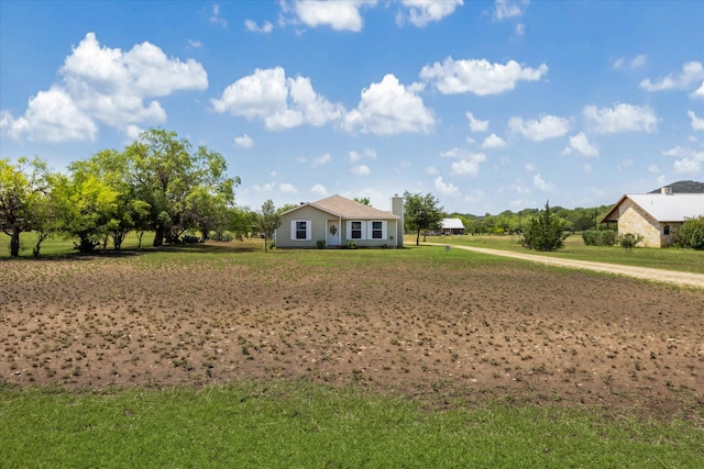 115 N River Place Rd, Rio Frio, TX 78879 - view of front facade featuring a chimney and a front lawn