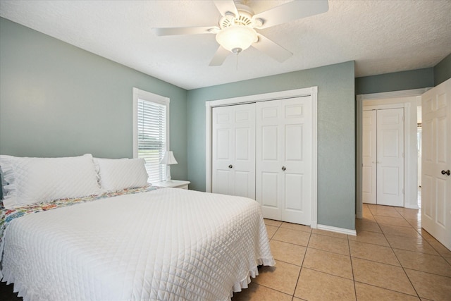 115 N River Place Rd, Rio Frio, TX 78879 - bedroom with light tile patterned flooring, a closet, a ceiling fan, and baseboards