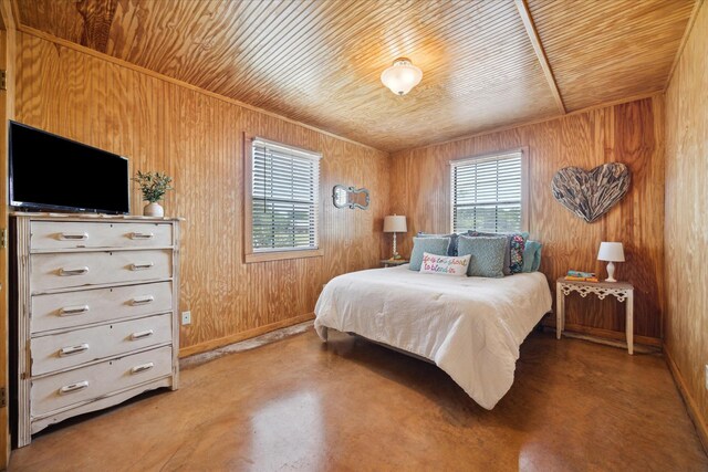 115 N River Place Rd, Rio Frio, TX 78879 - bedroom featuring finished concrete floors, wooden ceiling, wooden walls, and baseboards