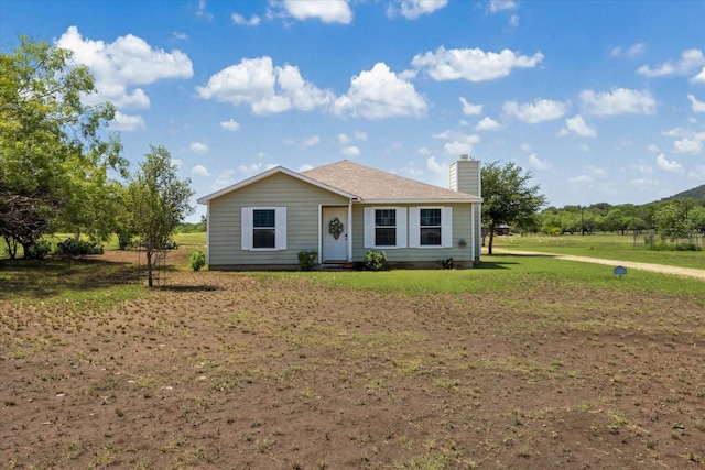 115 N River Place Rd, Rio Frio, TX 78879 - view of front of house with a chimney and a front lawn
