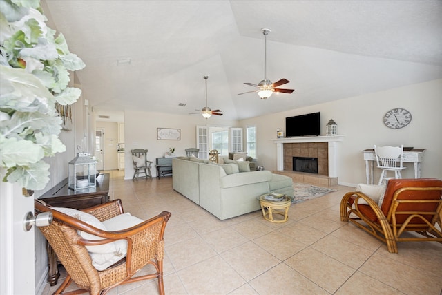 115 N River Place Rd, Rio Frio, TX 78879 - living room featuring light tile patterned floors, lofted ceiling, a tile fireplace, and a ceiling fan