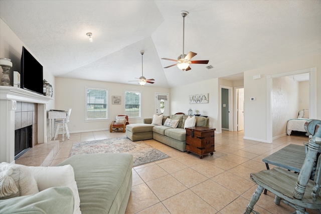 115 N River Place Rd, Rio Frio, TX 78879 - living room featuring light tile patterned floors, vaulted ceiling, a ceiling fan, a tile fireplace, and baseboards
