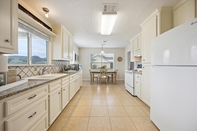 115 N River Place Rd, Rio Frio, TX 78879 - kitchen with white appliances, a sink, decorative backsplash, light tile patterned flooring, and under cabinet range hood