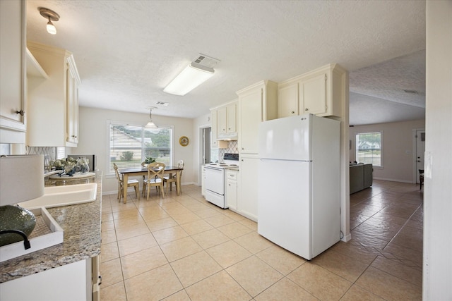 115 N River Place Rd, Rio Frio, TX 78879 - kitchen featuring white appliances, light tile patterned floors, baseboards, a textured ceiling, and hanging light fixtures
