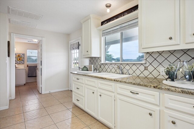 115 N River Place Rd, Rio Frio, TX 78879 - kitchen featuring a sink, healthy amount of natural light, tasteful backsplash, and baseboards