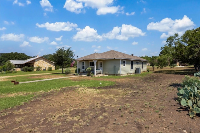 115 N River Place Rd, Rio Frio, TX 78879 - back of property with central air condition unit and a lawn