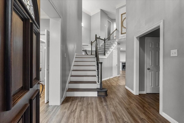 16610 Avenfield Rd, Tomball, TX 77377 - foyer entrance with stairway, wood finished floors, a towering ceiling, crown molding, and a fireplace
