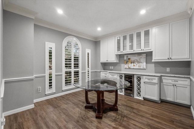 16610 Avenfield Rd, Tomball, TX 77377 - kitchen with wine cooler, crown molding, light countertops, white cabinetry, and dark wood-style flooring