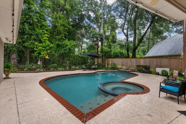 16610 Avenfield Rd, Tomball, TX 77377 - view of pool with a patio area, a pool with connected hot tub, a fenced backyard, and view of wooded area