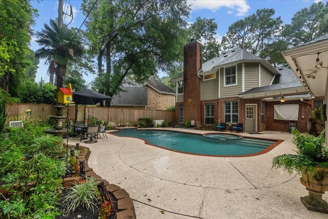 16610 Avenfield Rd, Tomball, TX 77377 - view of pool with a patio area, a fenced backyard, and a pool with connected hot tub